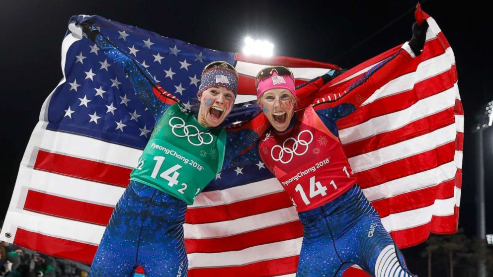 Americans Jessica Diggins, left and Kikkan Randall celebrate winning the gold medal in the women's cross country team sprint free final, Feb. 21, 2018.