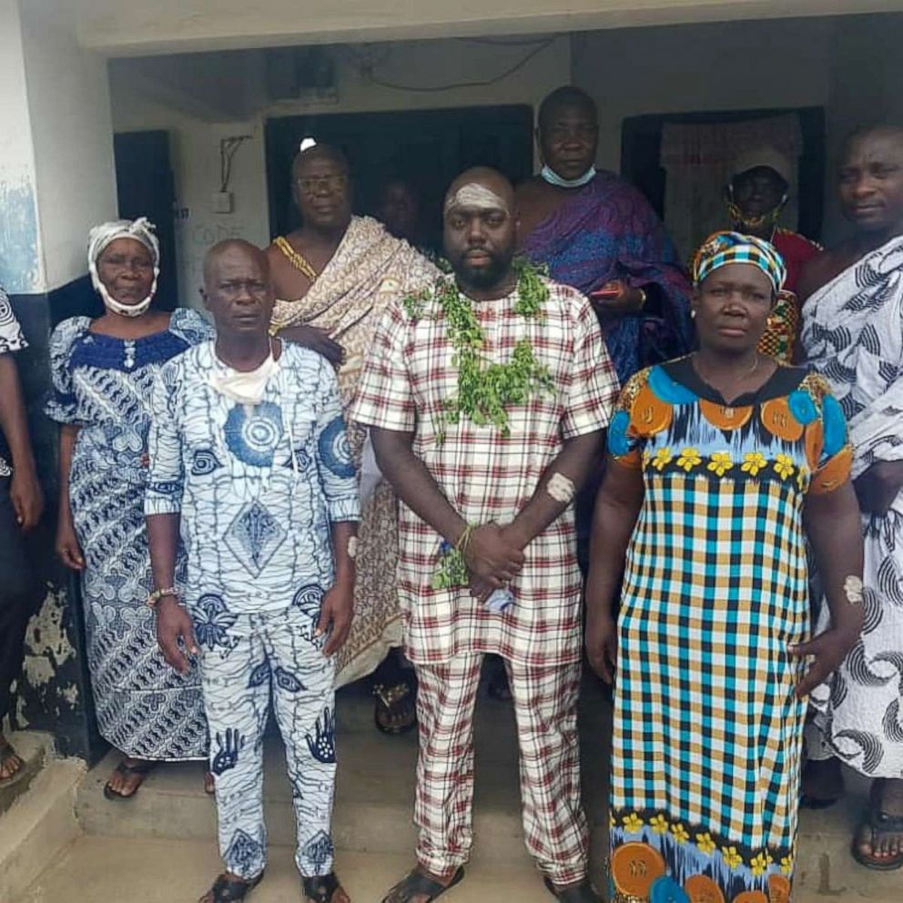 PHOTO: Rashad McCrorey (center) is welcomed by the royal family of Iture, a suburb of Elmina, Ghana, on June 20, 2020.