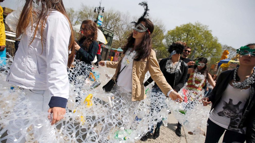 PHOTO: Demonstrators march together in plastic six pack rings during a demonstration to mark Earth Day in Manhattan, April 22, 2014, in this file photo in New York City.