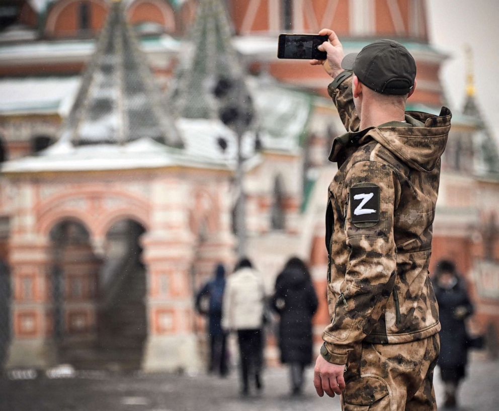 PHOTO: A man wearing military uniform with a Z letter, a tactical insignia of Russian troops in Ukraine, makes a selfie photo at Red Square in front of St. Basil's Cathedral in central Moscow, on Feb. 13, 2023.