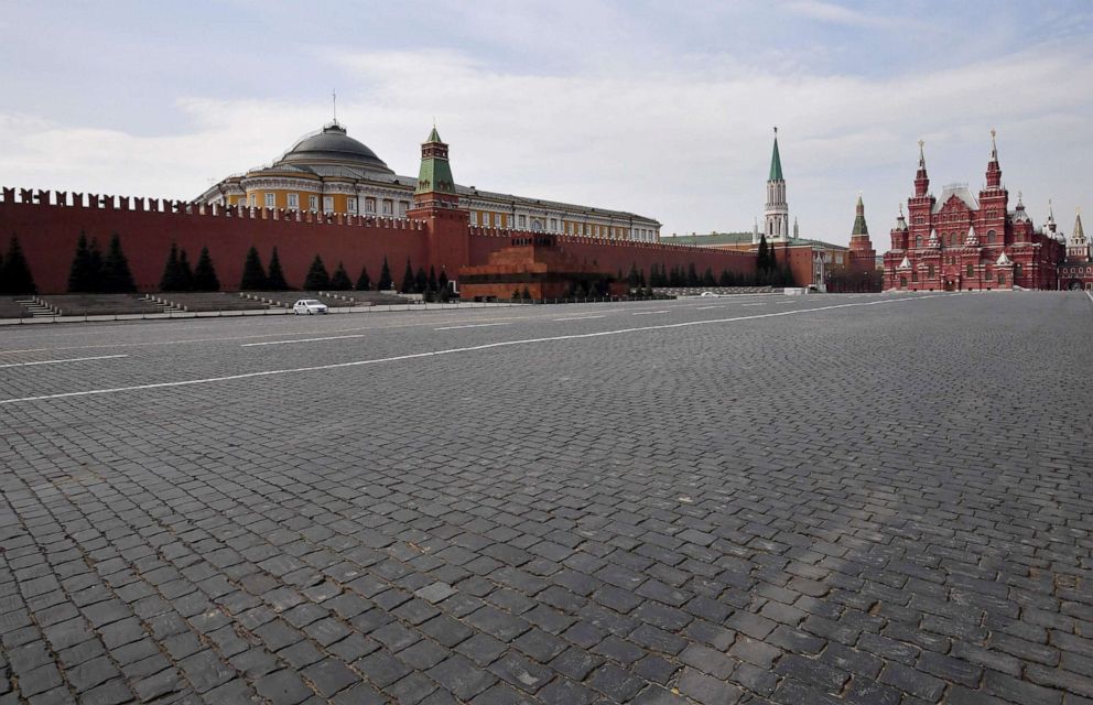 PHOTO: Police cars are seen on the deserted Red Square in Moscow, April 13, 2020, during a strict lockdown in Russia to stop the spread of the COVID-19 coronavirus.