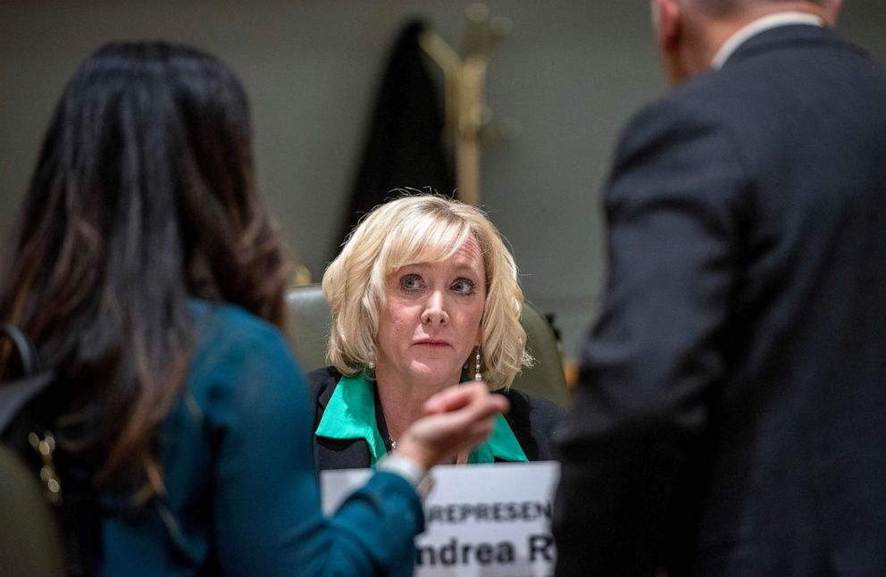 PHOTOS: Rep.  Andrea Reeb talks with people on the floor of the New Mexico House of Representatives before the start of a session, Feb.  1, 2023, in Santa Fe, New Mexico.