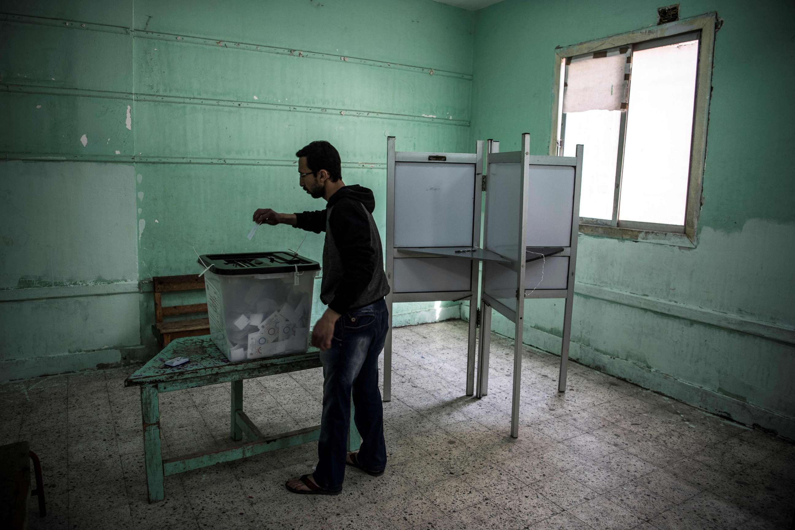 PHOTO: TAn Egyptian man casts his vote in a polling station during the third day of a referendum on constitutional amendments in Cairo, April 22, 2019. 