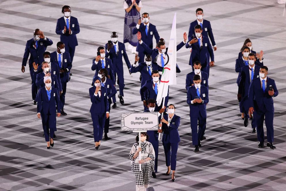 PHOTO: Yusra Mardini of the Refugee Olympic Team and Tachlowini Gabriyesos of the Refugee Olympic Team lead their contingent in the athletes parade during the opening ceremony of the Tokyo 2020 Olympic games.