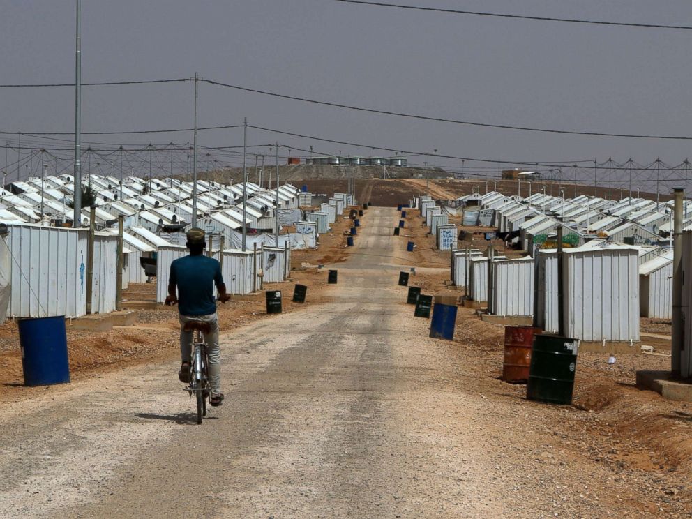 PHOTO: A Syrian refugee boy rides his bike under the hot sun near his makeshift home at the Azraq camp for Syrian refugees, the newest camp in Jordan that hosts 54.000 refugees in northeastern desert in Azraq, Jordan, July 13, 2017.