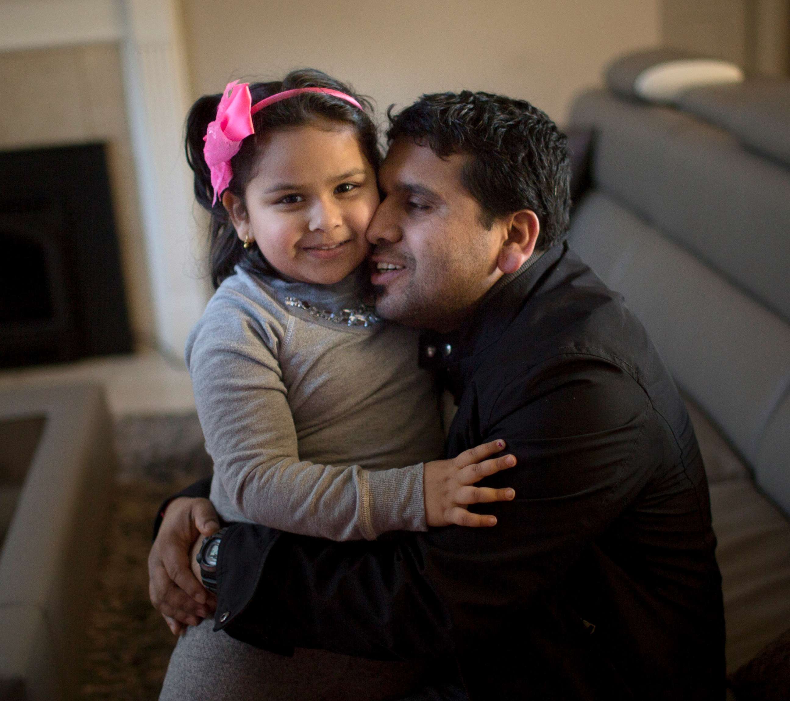 PHOTO: Somu Timsina hugs his daughter in Colchester, Vermont, Feb. 2, 2016. He moved to the area with the assistance of the Vermont Refugee Resettlement Program, which has resettled over 1700 other Nepali-Bhutanese refugees in the state since 2008. 
