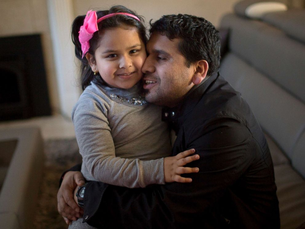 PHOTO: Somu Timsina hugs his daughter in Colchester, Vermont, Feb. 2, 2016. He moved to the area with the assistance of the Vermont Refugee Resettlement Program, which has resettled over 1700 other Nepali-Bhutanese refugees in the state since 2008.