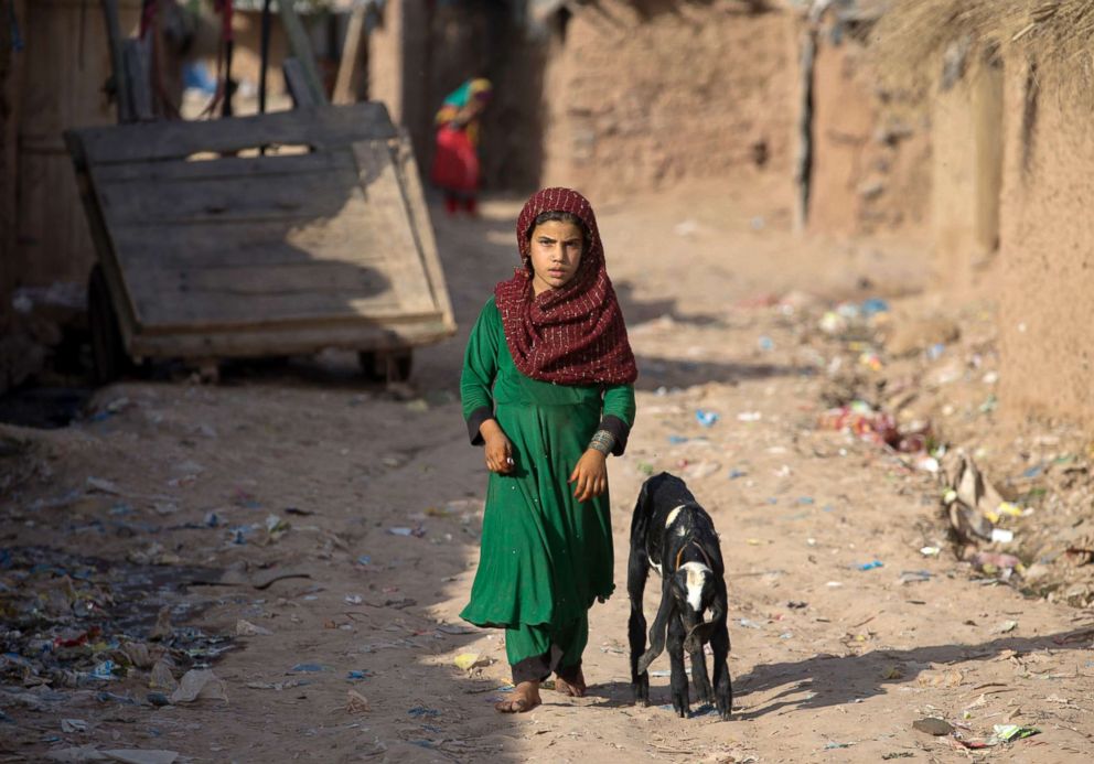 PHOTO: An girl from neighboring Afghanistan, who fled her village with her family due to war and famine, walks in a refugee camp in a suburb of Islamabad, Pakistan, June 19, 2018.