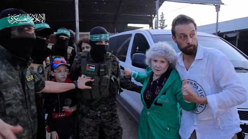 PHOTO: Hostages who were abducted by Hamas gunmen during the October 7 attack on Israel are handed over by Hamas militants to the International Red Cross in an unknown location in the Gaza Strip, Nov. 24, 2023. 
