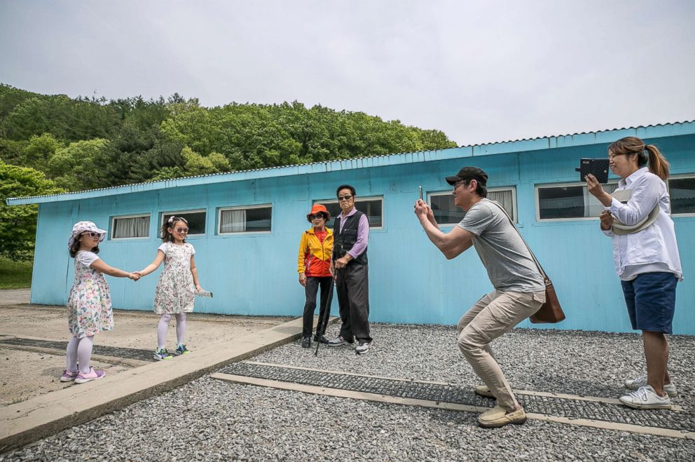 PHOTO: Visitors pose for photos at a replica of the DMZ border truce village of Panmunjom, built as a film set, near Namyangju, east of Seoul on May 5, 2018.