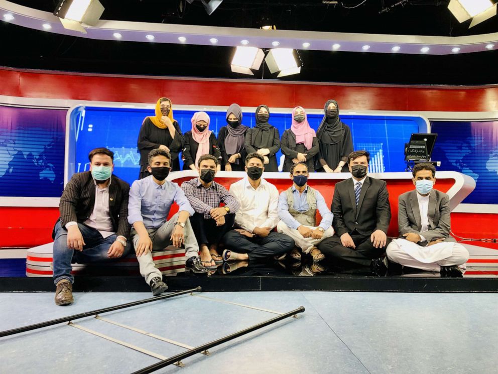 PHOTO: Afghan male staff at Tolo TV wears face masks to show solidarity with their female colleagues who are ordered to cover their faces at the studio in Kabul, Afghanistan, May 23, 2022.