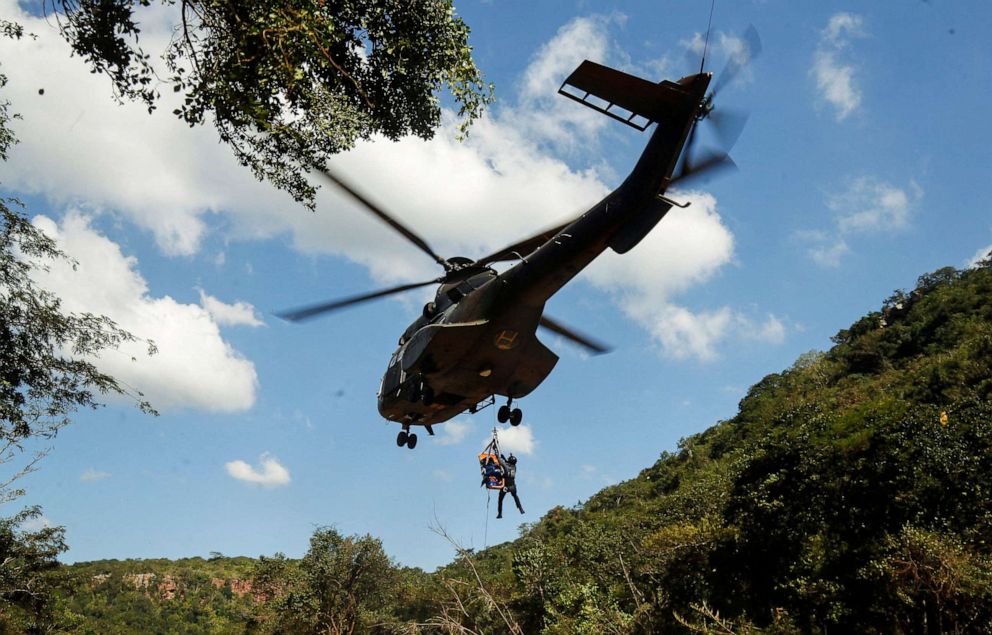 PHOTO: A member of a search and rescue team airlifts a body from the Mzinyathi River after heavy rains caused flooding near Durban, South Africa, April 19, 2022.