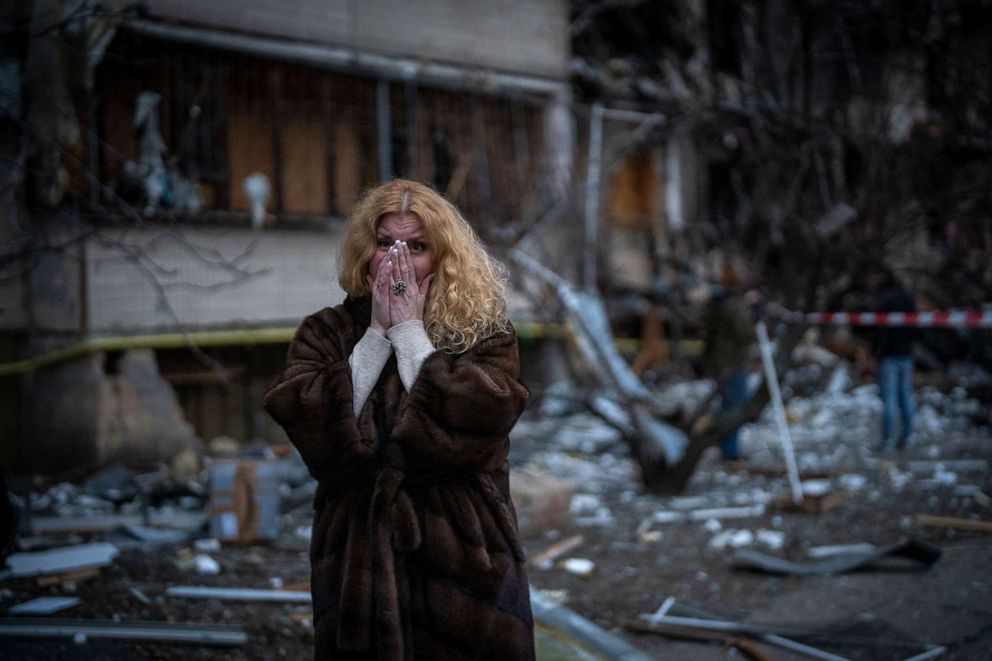 PHOTO: Natali Sevriukova reacts as she stands next to her home following a rocket attack in Kyiv, Ukraine, Feb. 25, 2022.