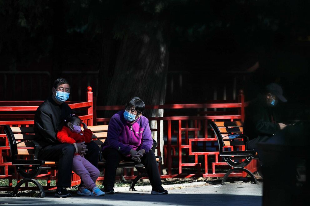 PHOTO: Residents wearing face masks to protect against the novel coronavirus spend time at a park in Beijing, China, on Nov. 10, 2020.