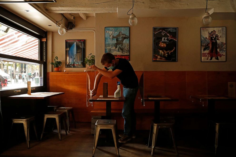 PHOTO: Casper Caluwe, manager of Japanese restaurant Umamido, cleans the restaurant as he gets ready to welcome customers for take-away service in downtown Brussels, Belgium, on Oct. 19, 2020.