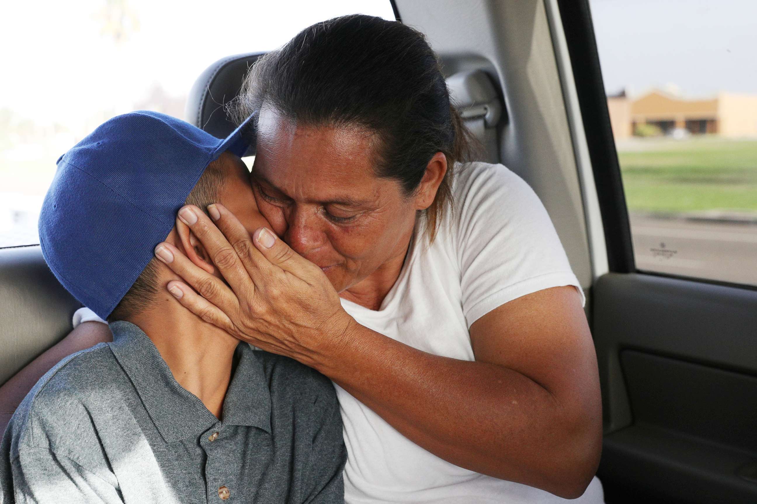 PHOTO: Maria Marroquin Perdomo and her 11-year-old son Abisai drive away from the Casa Padre facility in the backseat of her attorney's truck minutes after mother and son were reunited in Brownsville, Texas, July 14, 2018.