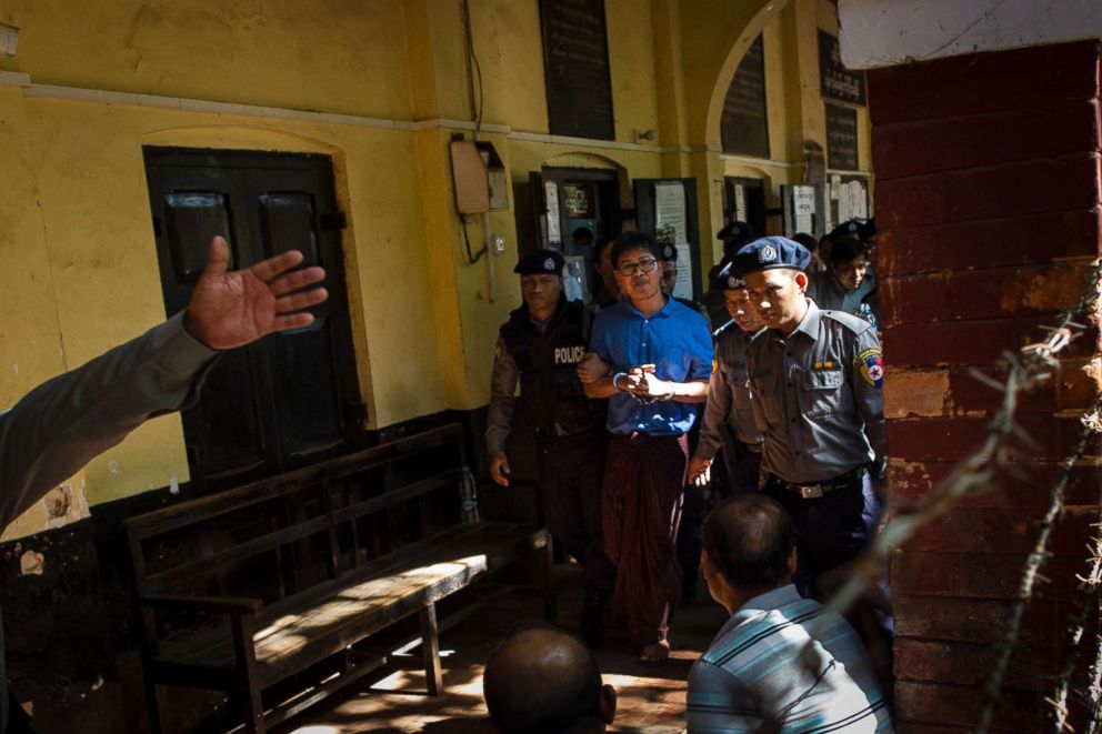 PHOTO: Reuters journalist Wa Lone (C) is escorted by police after a court appearance in Yangon, Jan. 10, 2018.
