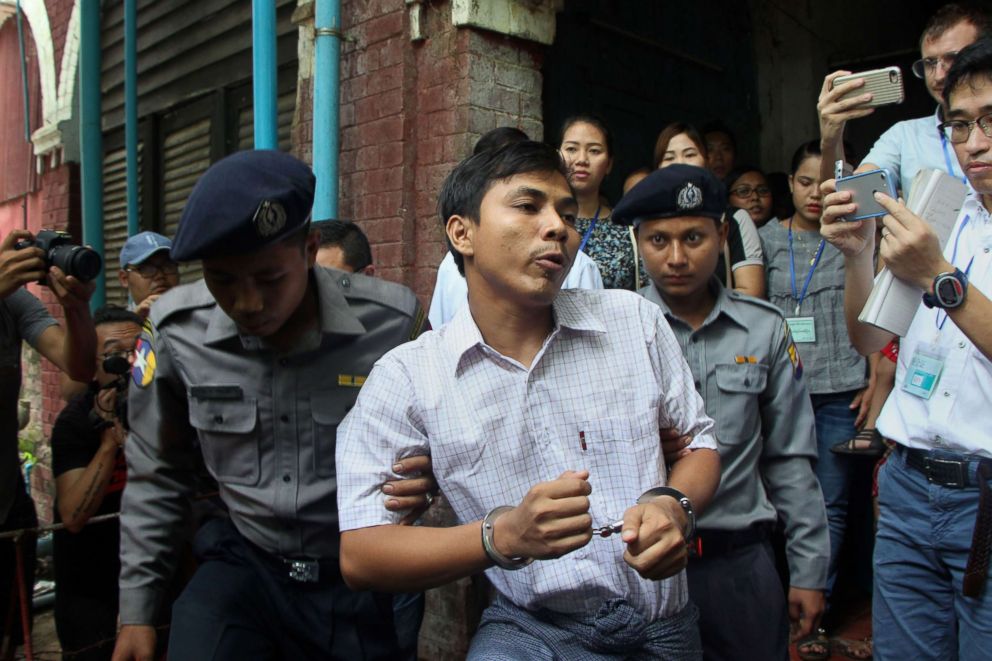 PHOTO: Detained Myanmar journalist Kyaw Soe Oo (C) is escorted by police to a court for his ongoing trial in Yangon, May 2, 2018. 