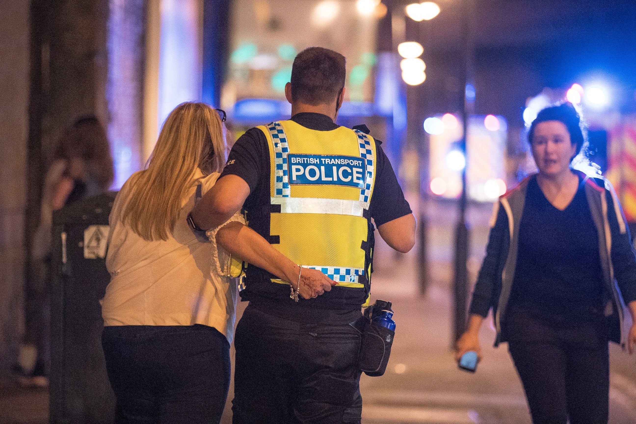 PHOTO: A police officer helps a woman near the Manchester Arena after reports of an explosion, May 22, 2017.