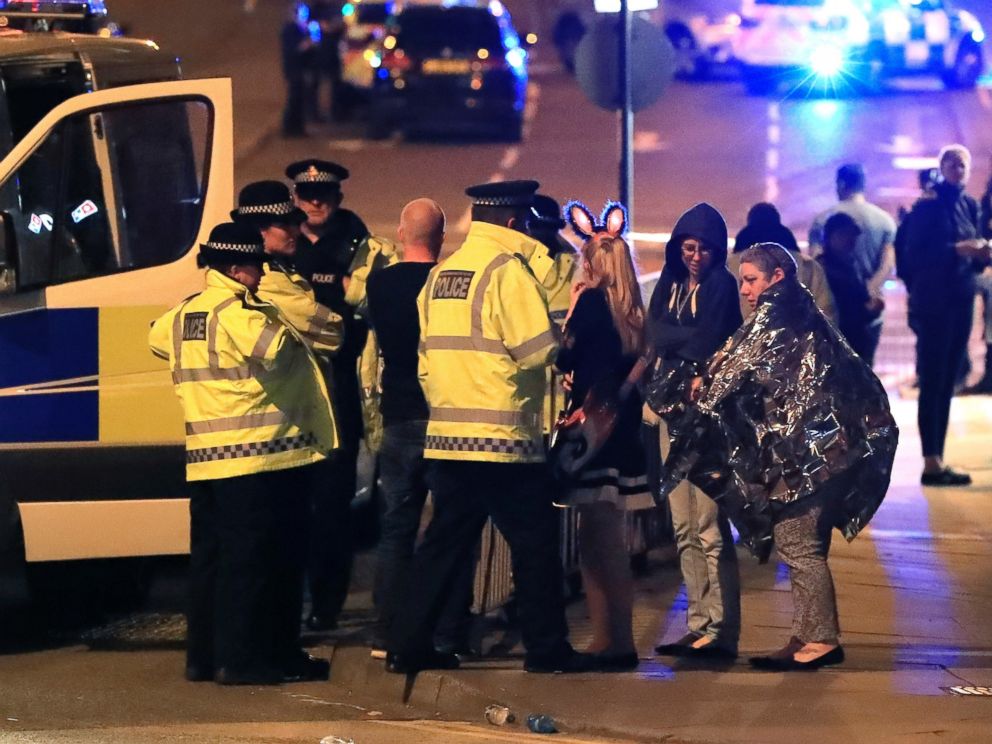 PHOTO: Emergency services personnel speak to people outside Manchester Arena after reports of an explosion at the venue during an Ariana Grande concert in Manchester, England, May 22, 2017.