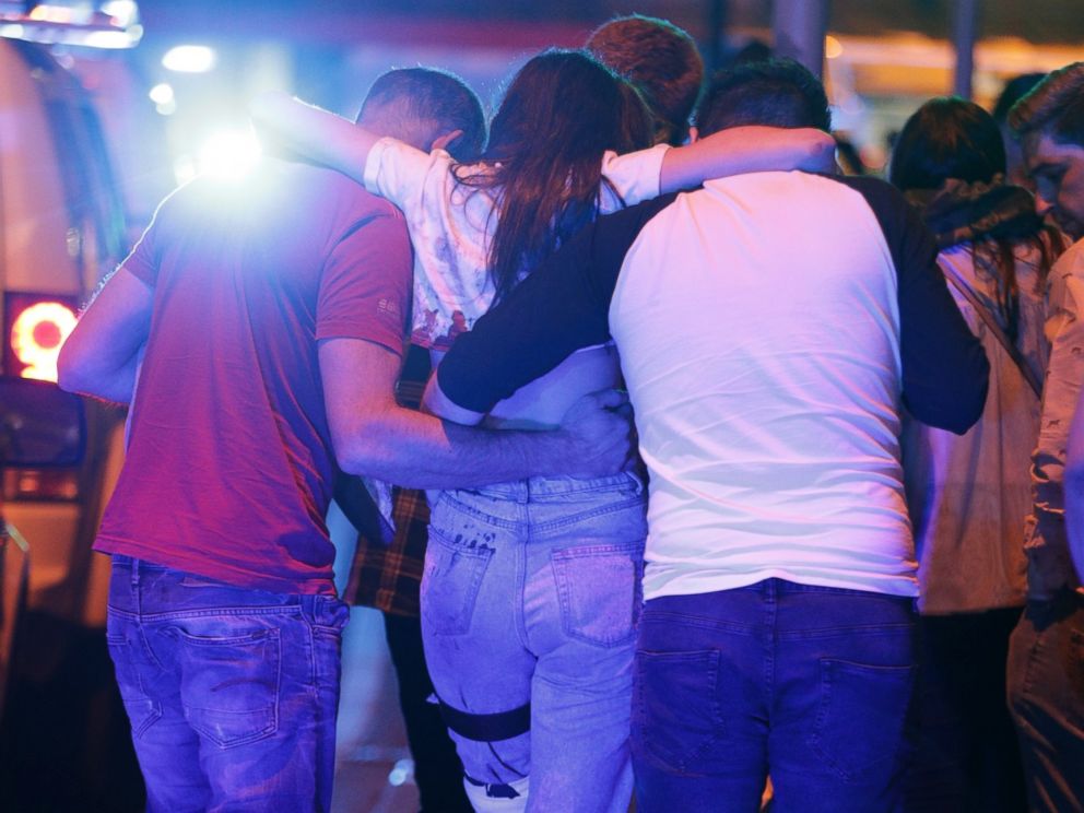 PHOTO: People help an injured woman walk near the Manchester Arena after reports of an explosion on May 22, 2017 in Manchester, England.