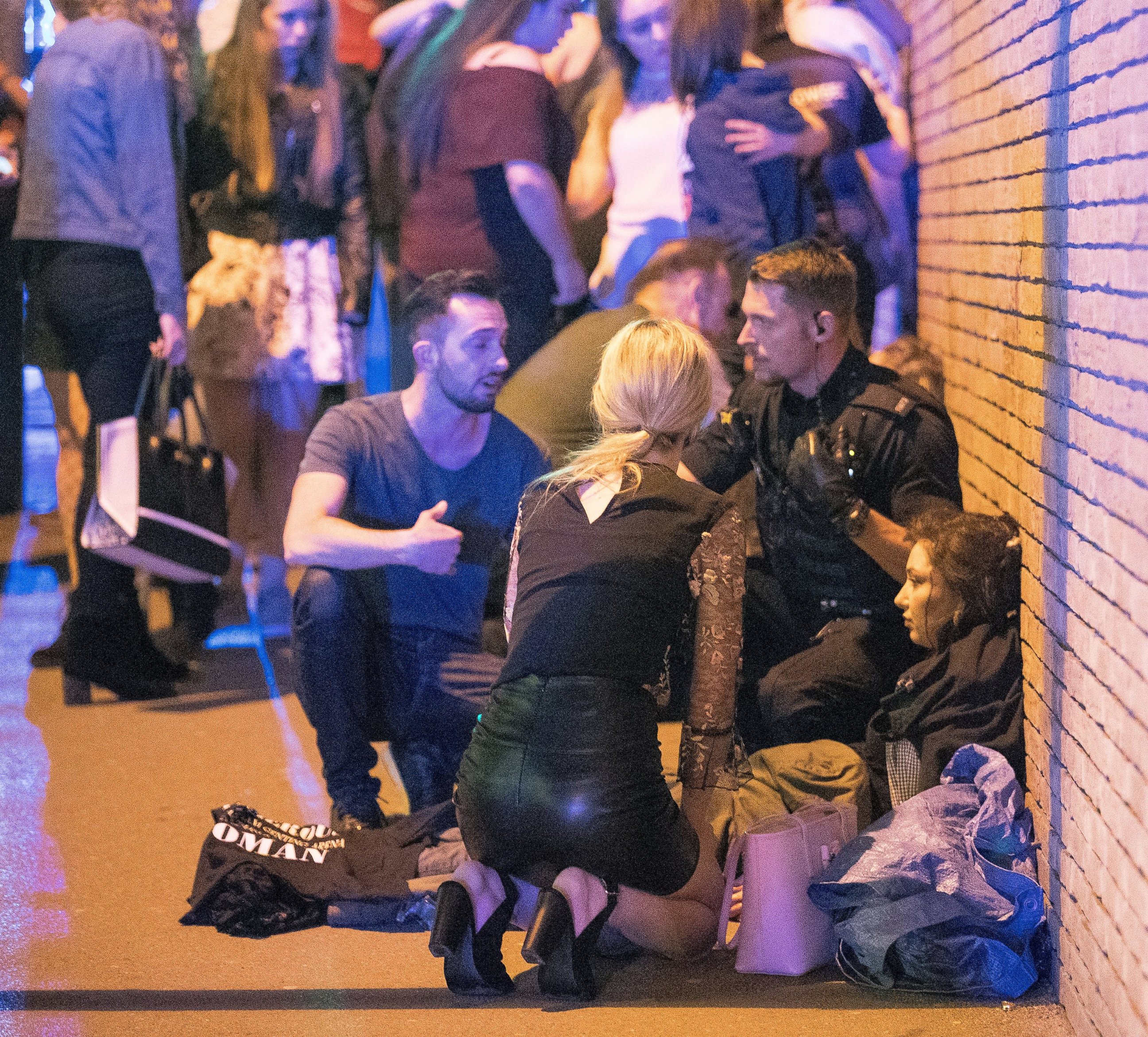 PHOTO: People gather near the Manchester Arena after reports of an explosion on May 22, 2017 in Manchester, England.