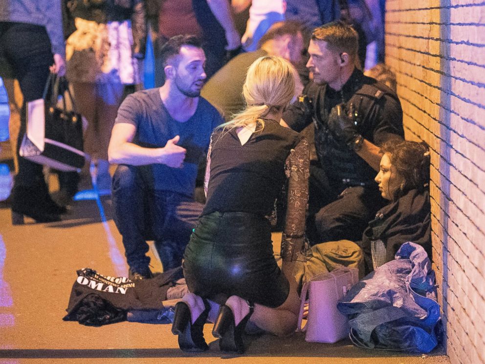 PHOTO: People gather near the Manchester Arena after reports of an explosion on May 22, 2017 in Manchester, England.