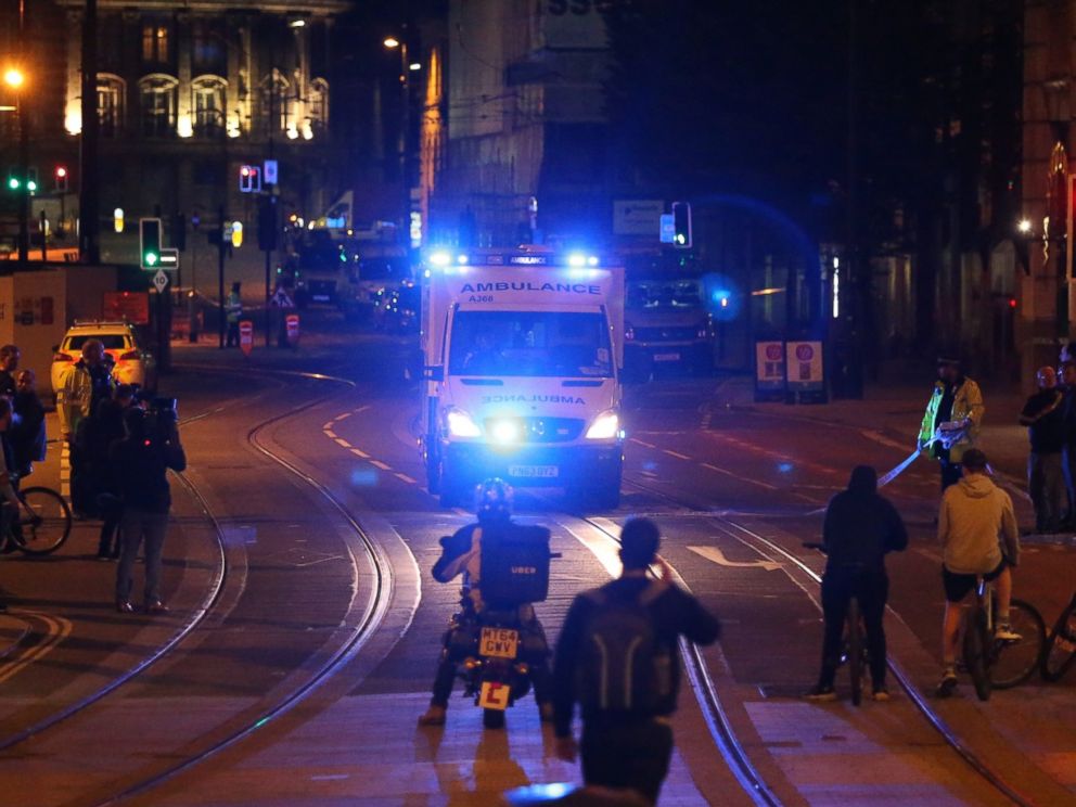 PHOTO: People watch an ambulance pass in the street near Manchester Arena after reports of an explosion in Manchester, England, May 23, 2017.