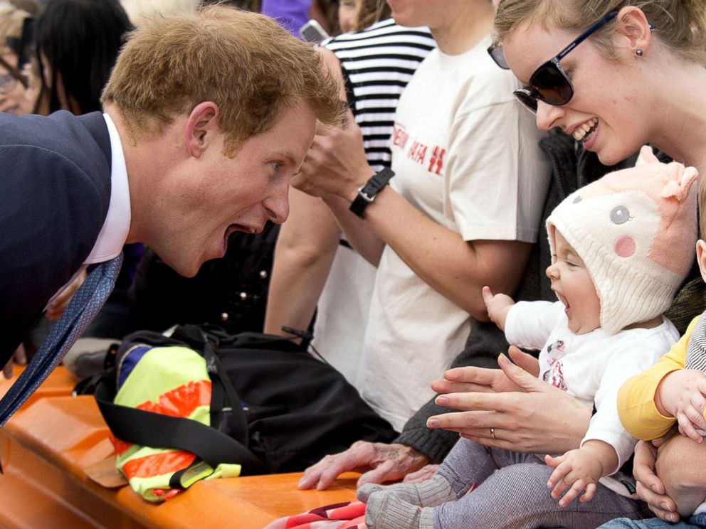 PHOTO: Prince Harry greets a baby at Cashel Street Mall in Christchurch, New Zealand, May 12, 2015.