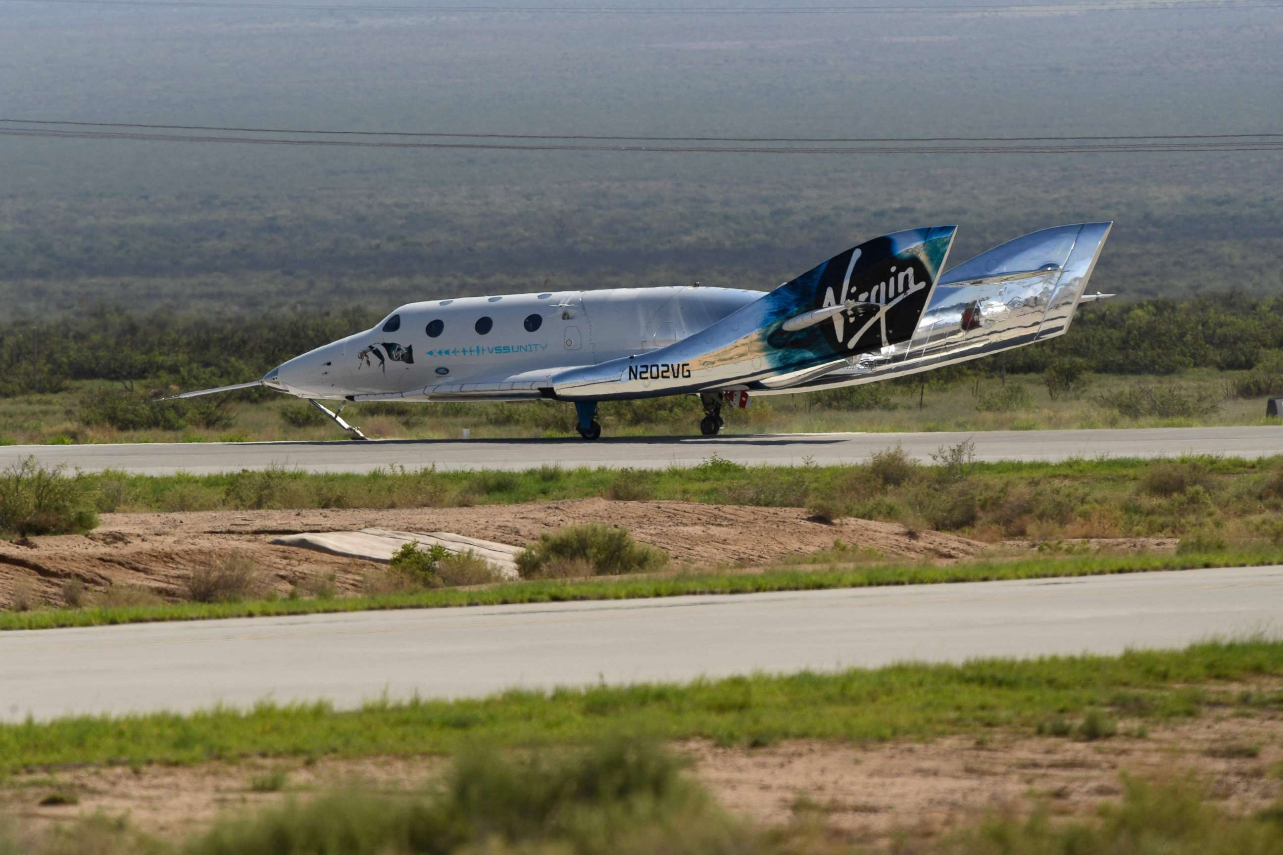 PHOTO: The Virgin Galactic SpaceShipTwo space plane Unity returns to earth after the mothership separated at Spaceport America, near Truth and Consequences, New Mexico on July 11, 2021.