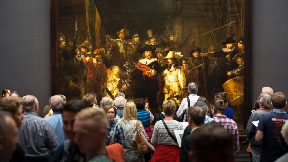 PHOTO: Visitors view famous 17th Century painting by Rembrandt "The Night Watch" at Rijksmuseum in Amsterdam, June 9, 2015.