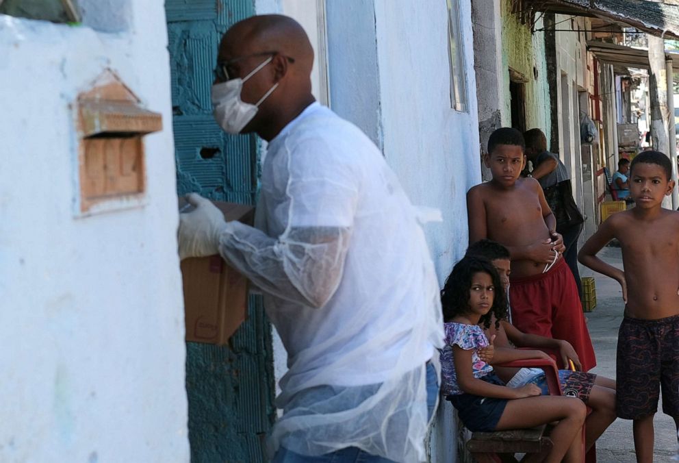 PHOTO: A volunteer delivers donated aid to poor families in Rio de Janeiro's slums through Single Centre of Slums (CUFA) during the coronavirus disease (COVID-19) outbreak, in Vila Kennedy slum in Rio de Janeiro, Brazil, April 2, 2020.