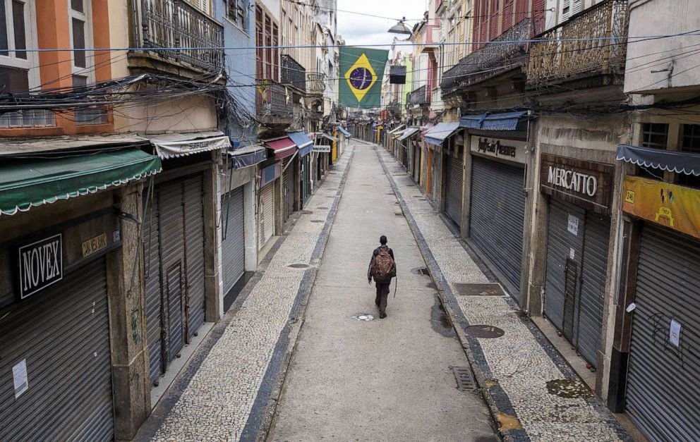 PHOTO: A pedestrian walks through a nearly empty shopping area in the center of the Rio de Janeiro, Brazil, during a lockdown aimed at stopping the spread of the (COVID-19) coronavirus pandemic, March 24, 2020.