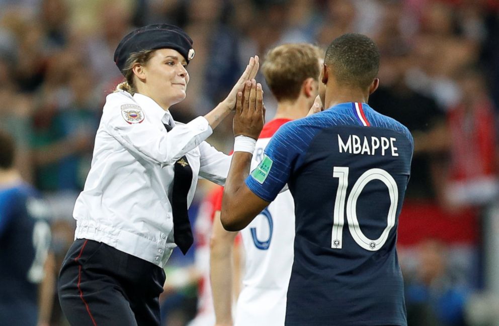 PHOTO: Veronika Nikulshina of Pussy Riot high fives France's Kylian Mbappe after she staged a pitch invasion during the World Cup final in Moscow, July 15, 2018.