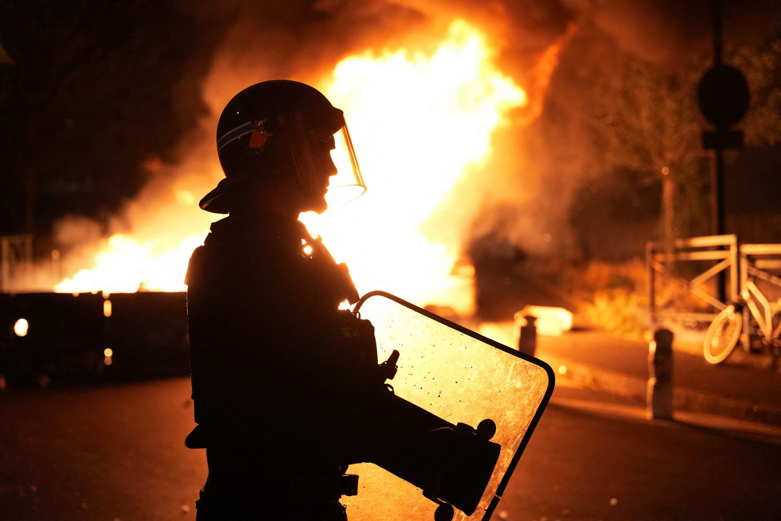 PHOTO: A firefighter looks on as vehicles burn amid riots in Nanterre, a suburb of Paris, France, on June 28, 2023, a day after police shot and killed a 17-year-old driver during a traffic check.