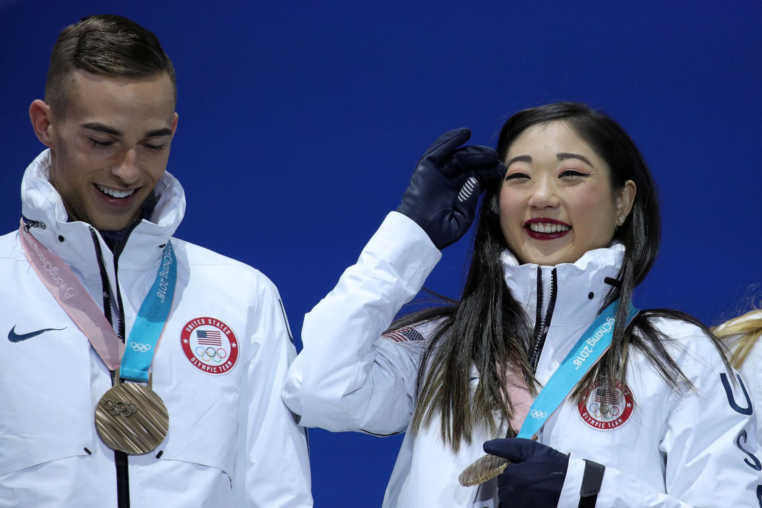 PHOTO: Bronze medalists Adam Rippon and Mirai Nagasu of team U.S. celebrate during the victory ceremony after the figure skating team event at Medal Plaza, Feb. 12, 2018, in Pyeongchang, South Korea. 