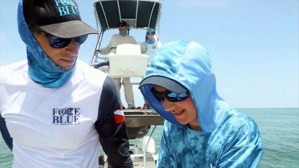 PHOTO: Father and son Force Blue team members Roger, left, and Oz Sparks search for green sea turtles.