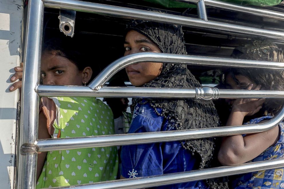 PHOTO: Rohingya Muslim women ride a police vehicle in Kyauktan township south of Yangon, Nov. 16, 2018, after their boat washed ashore. 