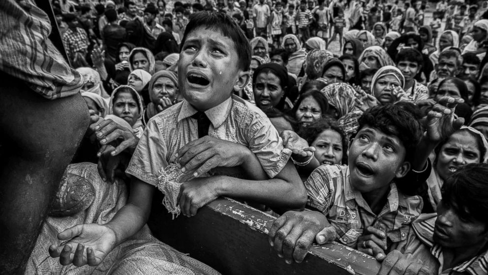 A Rohingya refugee boy desperate for aid cries as he climbs on a truck distributing aid for a local NGO near the Balukali refugee camp in Bangladesh, Sept. 20, 2017.
