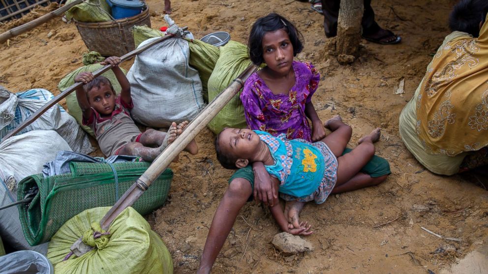 PHOTO: A Rohingya girl Shafiqa Begum, who spent four days in the open after crossing over from Myanmar into Bangladesh, holds her sister at Kutupalong refugee camp, Bangladesh, Oct. 19, 2017.