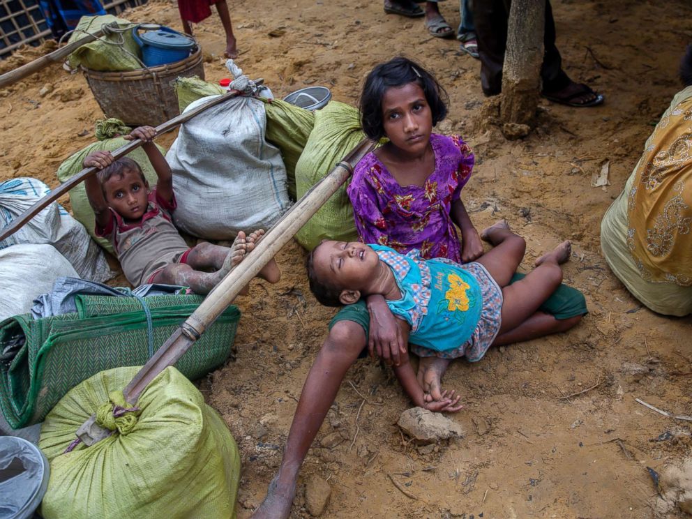 PHOTO: A Rohingya girl Shafiqa Begum, who spent four days in the open after crossing over from Myanmar into Bangladesh, holds her sister at Kutupalong refugee camp, Bangladesh, Oct. 19, 2017.