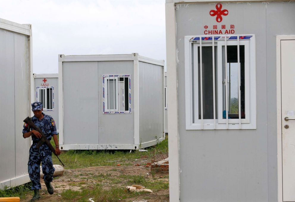 PHOTO: A border guard walks between cyclone shelters built by China Aid for returnees at Hla Phoe Khaung transit camp in Maungdaw township, Rakhine State, western Myanmar, Aug. 23, 2018.