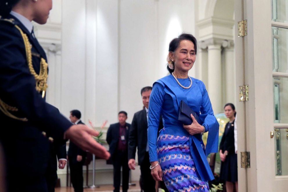 PHOTO: Myanmar State Counsellor Aung San Suu Kyi is ushered by an aide-de-camp at the Istana Presidential Palace in Singapore, Aug. 21, 2018.