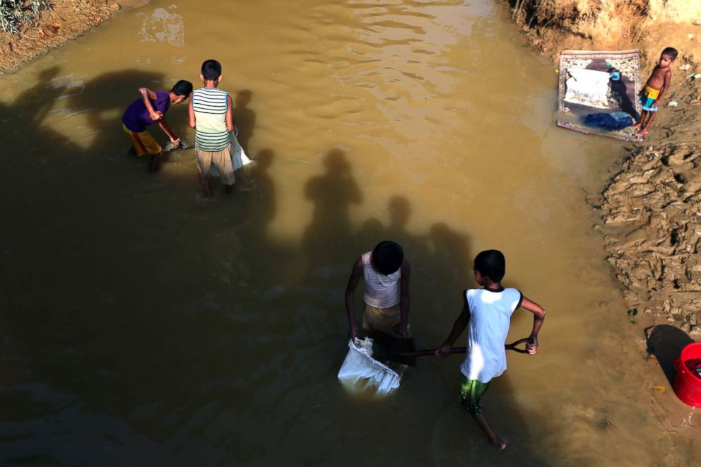 PHOTO: Rohingya children collect sand form the canal to repair there madrassha in the Kutupalong camp in Cox's Bazar, Bangladesh, Oct. 18, 2018.