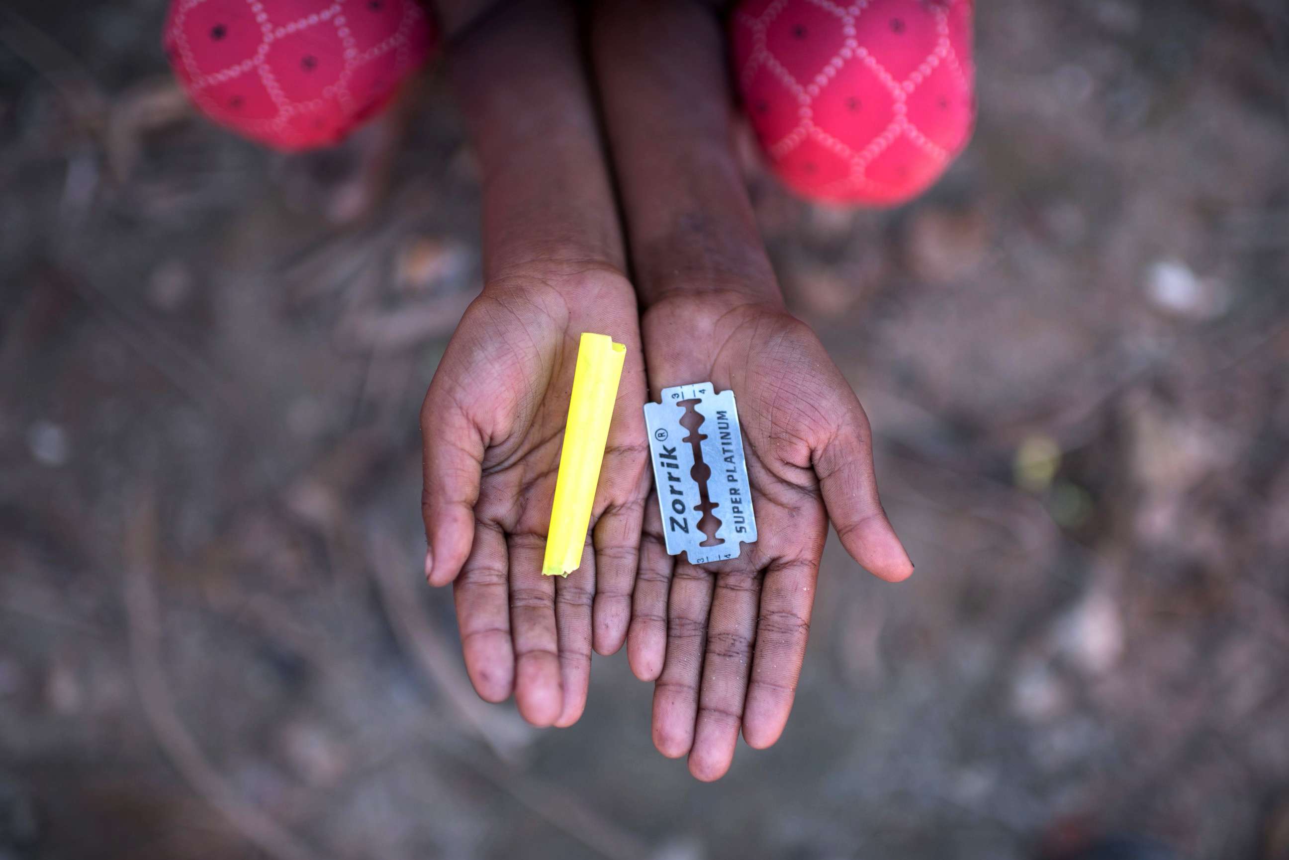 PHOTO: Rohingya migrant girl Halima Khatun (6), who arrived in Bangladesh in October, holds a whistle and a razor blade that she uses as toys at the Shamlapur refugee camp in Cox's Bazar, Dec. 1, 2017.