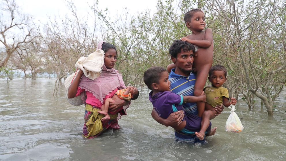 PHOTO: Rohingya refugees walk on the water after crossing the Naf River with an improvised raft to reach Bangladesh in Teknaf, Bangladesh on Nov. 12, 2017.