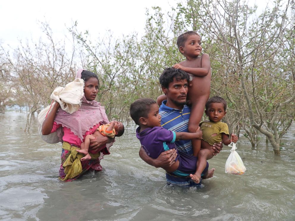 PHOTO: Rohingya refugees walk on the water after crossing the Naf River with an improvised raft to reach Bangladesh in Teknaf, Bangladesh on Nov. 12, 2017.