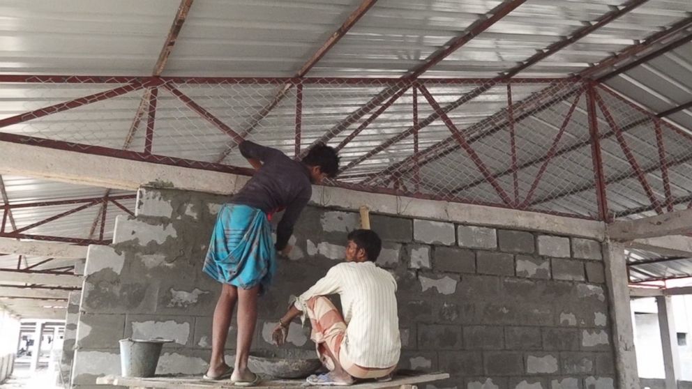 PHOTO: Men work on the housing development the Bangladesh government is building for thousands of Rohingya refugees.
