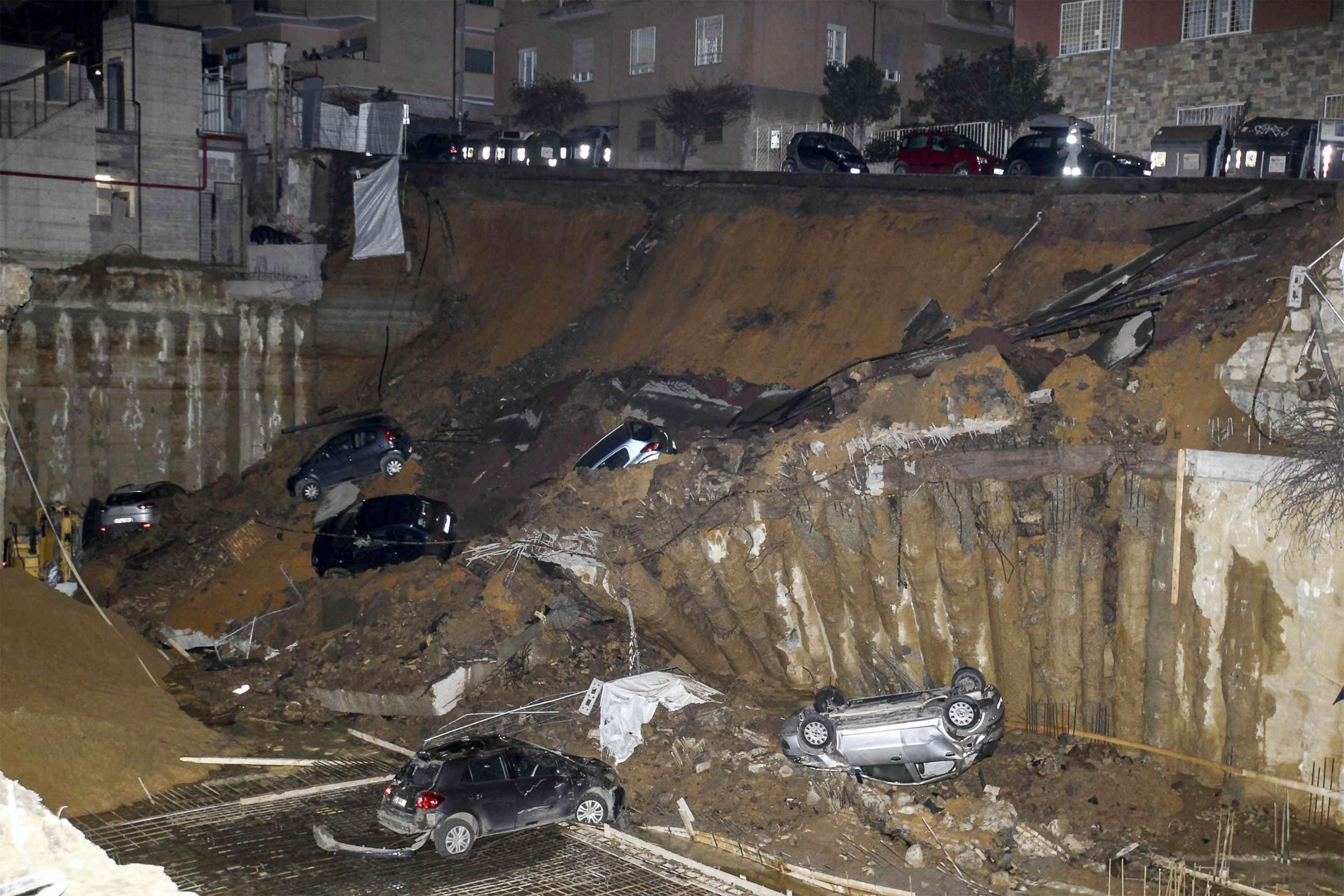 PHOTO: A view is captured of a large sinkhole that opened in a street of a residential area in Rome, on Feb. 14, 2018. 
