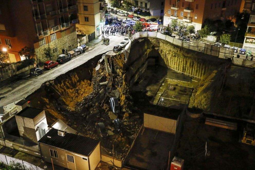 PHOTO: The view of a large sinkhole that opened in a street of a residential area in Rome on Feb. 14, 2018 is captured. 